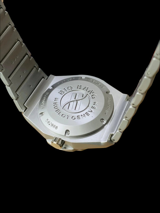 Hublot watch back with visible branding on a wooden surface